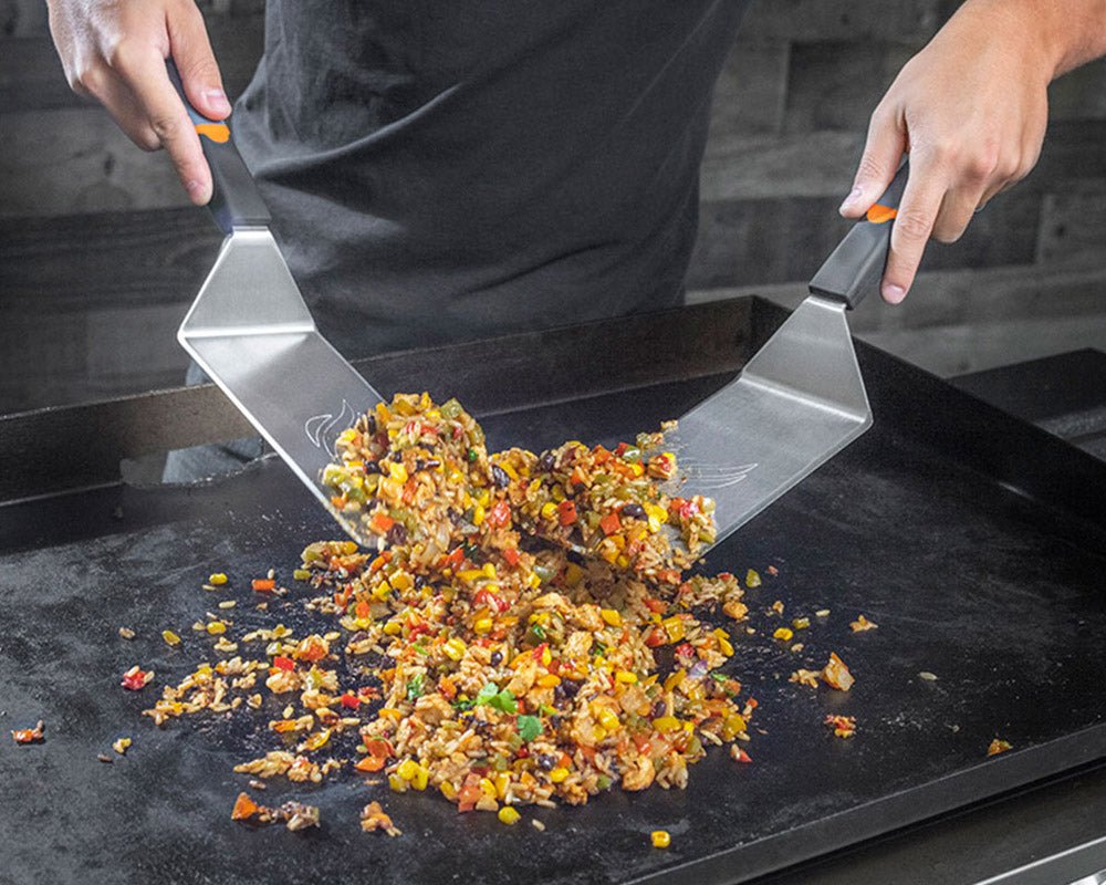 Spatulas in action mixing up some Spanish rice.