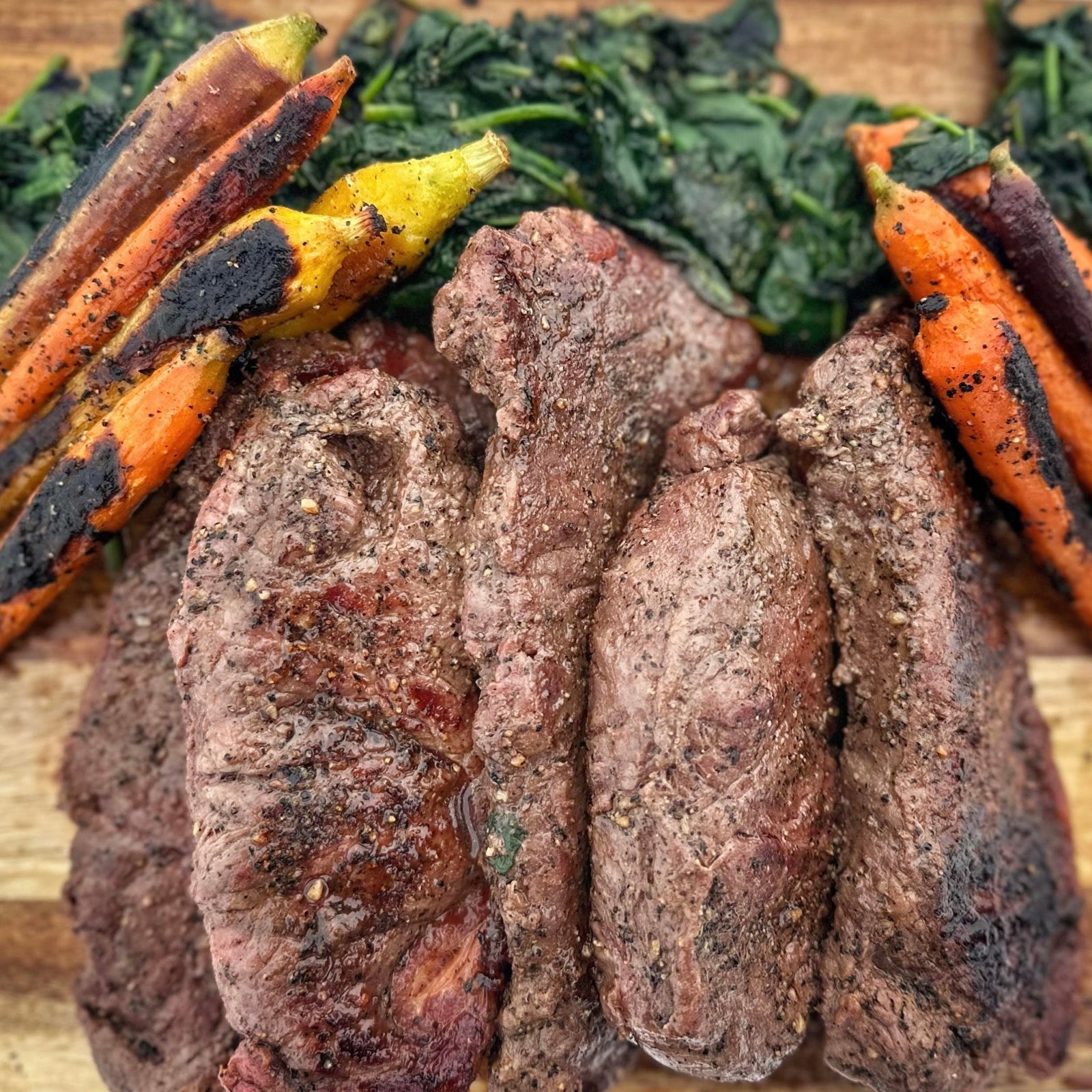 New York Strip Steaks with Baby Carrots and Spinach - Blackstone Products