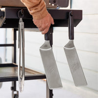 The side shelf hooks hold your cooking tools when not in use. 