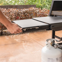 The extendable side shelf provides extra prep space and slides away for storage. 