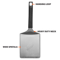 The spatula features a wide spatula base, heavy-duty neck, and hanging loop. 