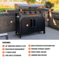 The griddle features a 36" Omnivore Griddle Plate, Rear Grease Management, an 'X' brace hood, side shelf extension, BAR System with accessory bin, propane storage cabinet, paper towel holder, and garbage bag holder. 