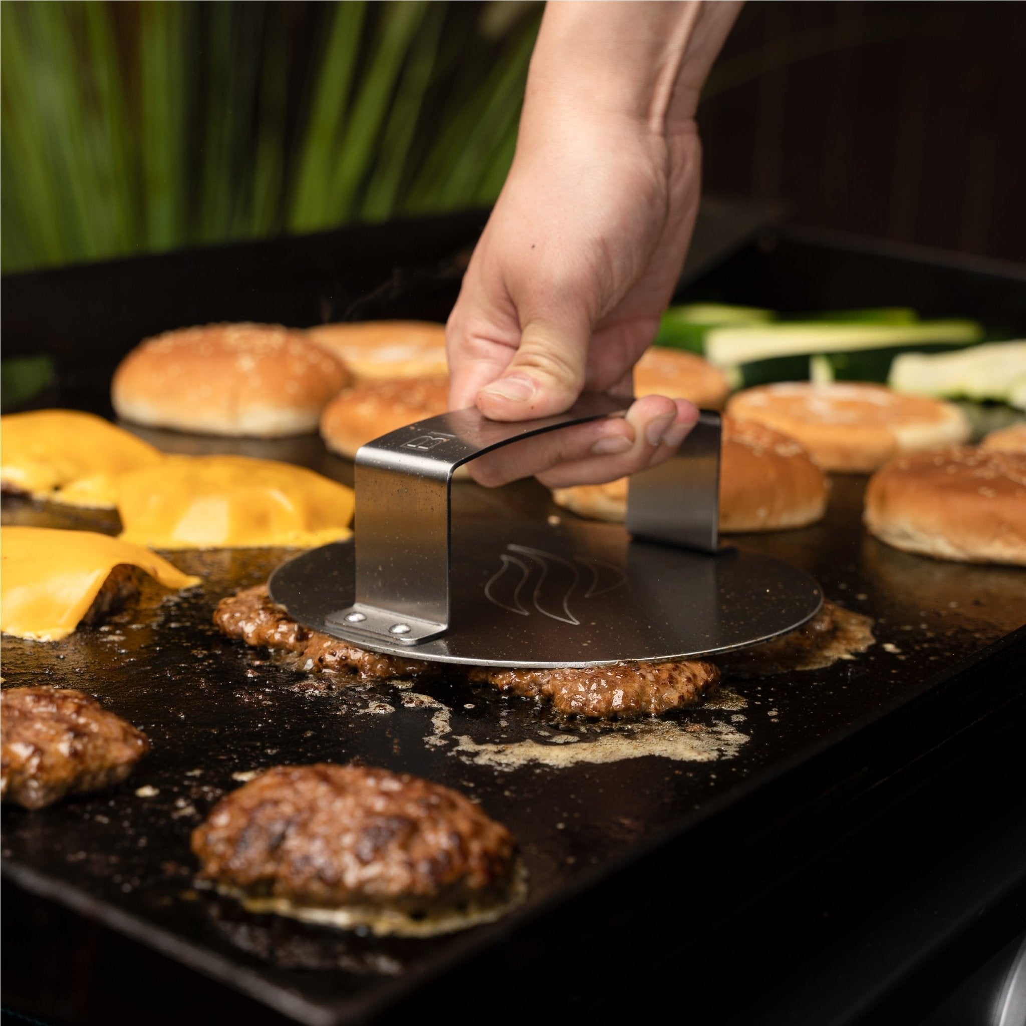 The included press creates perfect smash burgers every time. 