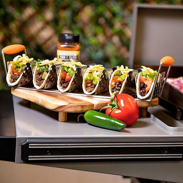 Six tacos placed on the taco rack. 